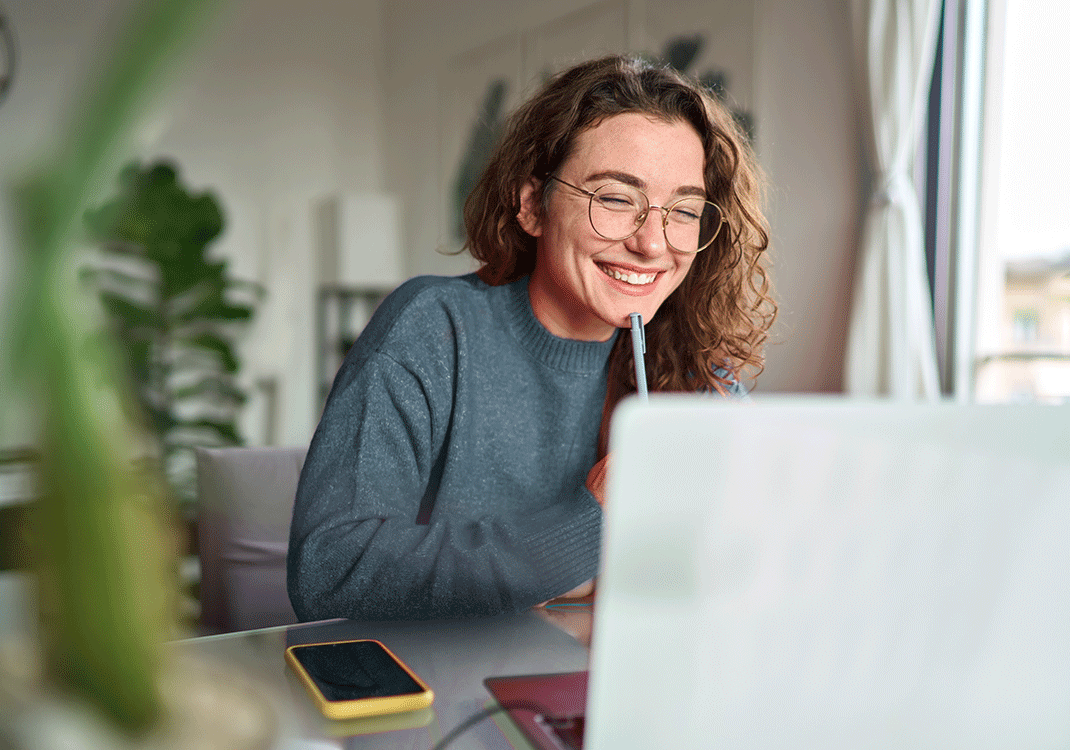 Woman with glasses looking at laptop screen