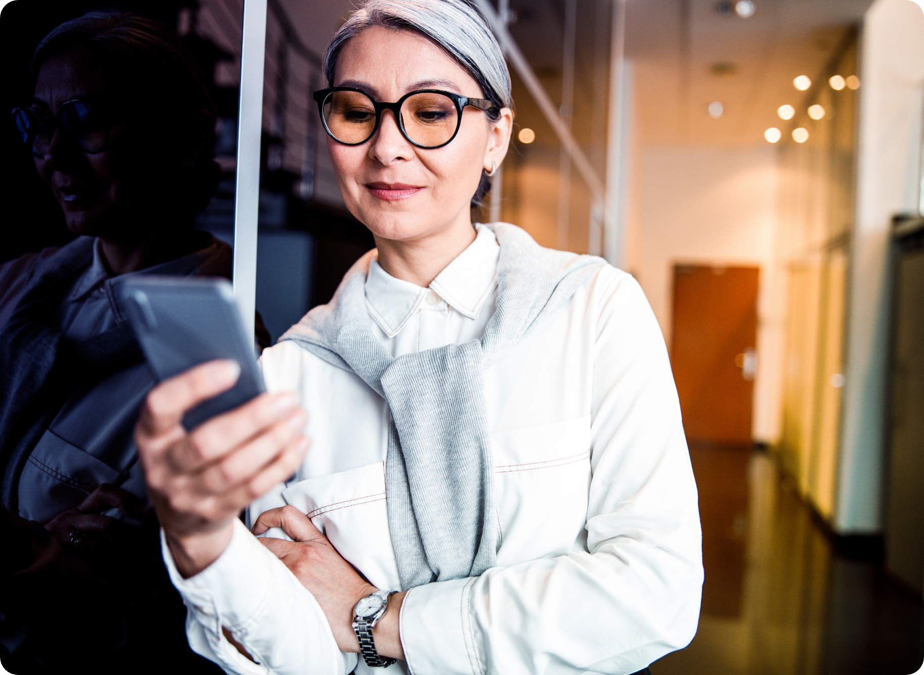 Woman holding a mobile phone with her hand